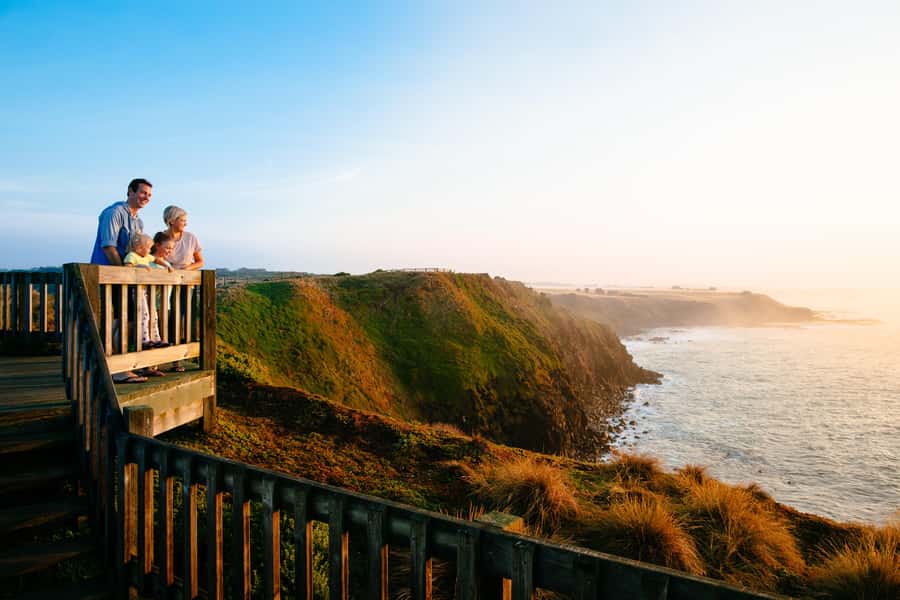 From Melbourne: Penguin Parade and Koalas Tour - Woolamai Beach and Cape Woolamai: toes in the sand, surfers in motion